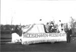 WR Abeling Sr along side a 'Moosehaven Mooseheart' float in a local parade. 